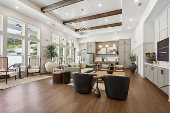 Living room with a high ceiling and wooden floors.